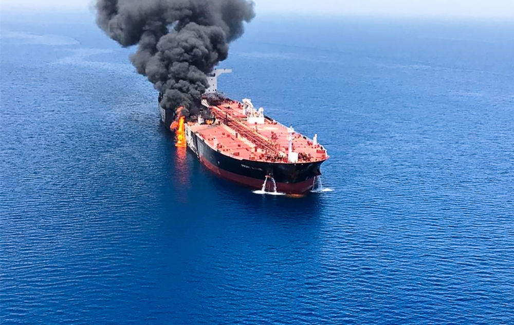 Fire and smoke billowing from a tanker said to have been attacked in the waters of the Gulf of Oman.   AFP / ISNA / -
