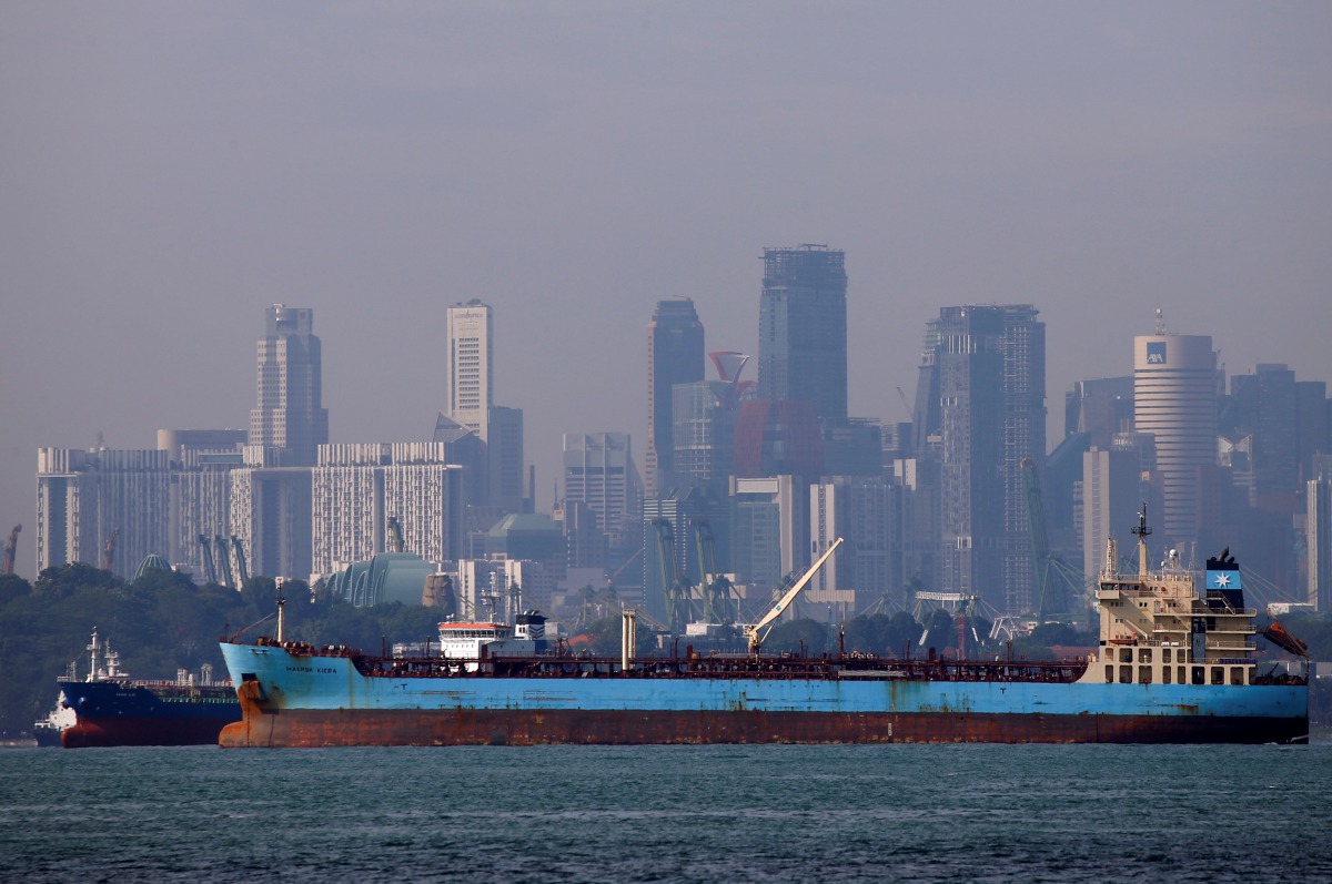 Oil tankers pass the skyline of Singapore, June 8, 2016. Reuters/Edgar Su