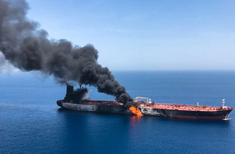 A picture obtained from Iranian News Agency on June 13, 2019 shows fire and smoke billowing from Norwegian owned Front Altair tanker said to have been attacked in the waters of the Gulf of Oman. AFP/ISNA