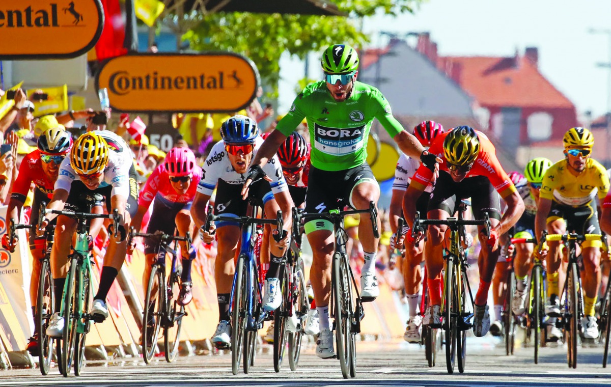 Slovakia's Peter Sagan (R), wearing the best sprinter's green jersey celebrates, past Belgium's Wout van Aert, wearing the best young's white jersey (L), as he wins on the finish line of the fifth stage of the 106th edition of the Tour de France cycling r