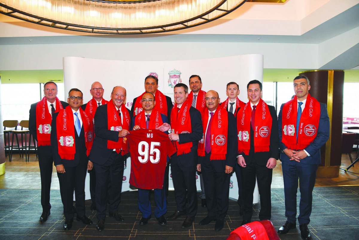 Officials of MG Motor and Liverpool FC pose for a group picture after signing the partnership agreement.