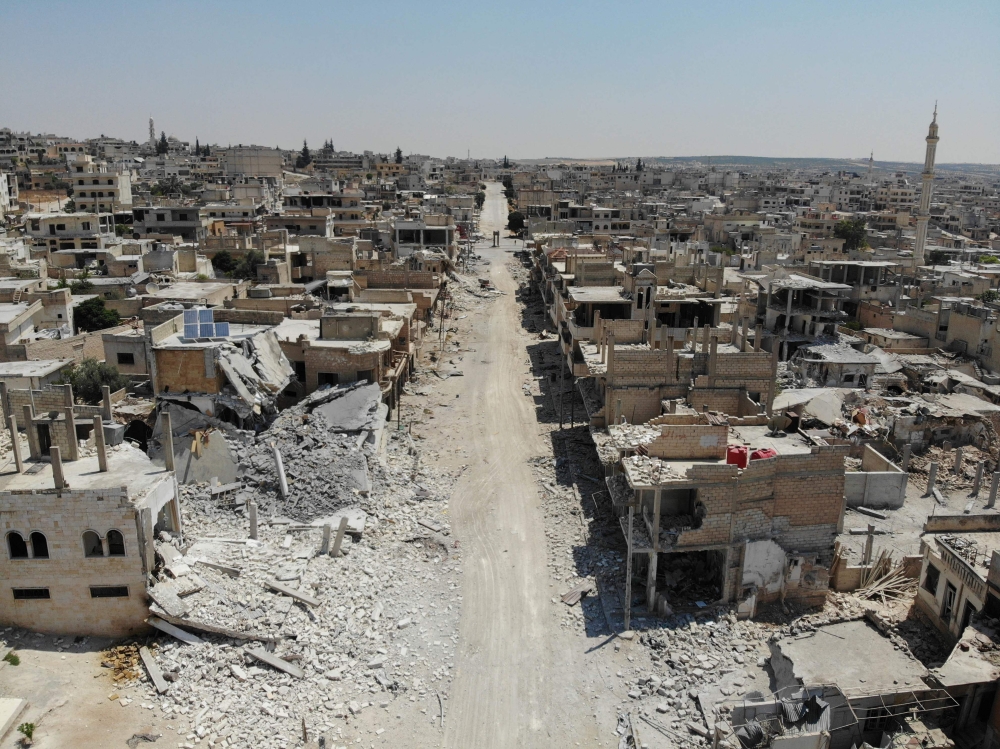 An aerial view taken on August 3, 2019, shows destroyed buildings in the town of Khan Sheikhun in the southern countryside of Idlib.   AFP / Omar HAJ KADOUR