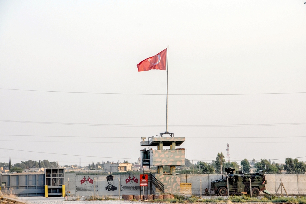 Turkish military truck patrols next to a Turkish flag hoisted at the border with Syria on August 14, 2019, in Akcakale, in Sanliurfa, southeastern Turkey.  AFP 