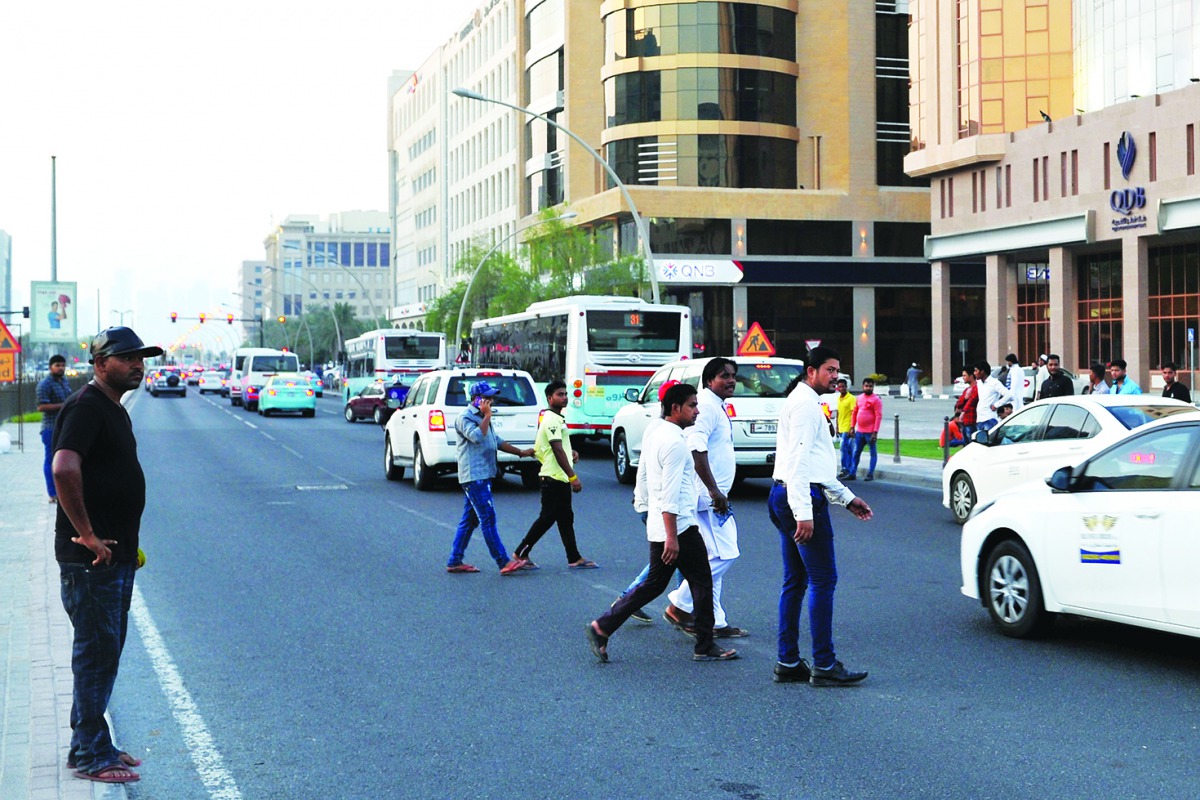 People crossing a busy road without observing traffic rules, in Doha. The Ministry of Interior has started recording traffic violations by pedestrians and will start imposing fines. Pic by: Salim Matramkot/The Peninsula
