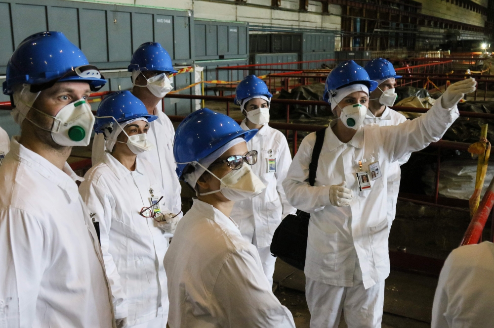 People take part in a guided tour at the inoperative Ignalina nuclear power plant in Visaginas, Lithuania, on July 31, 2019.  AFP / Petras Malukas