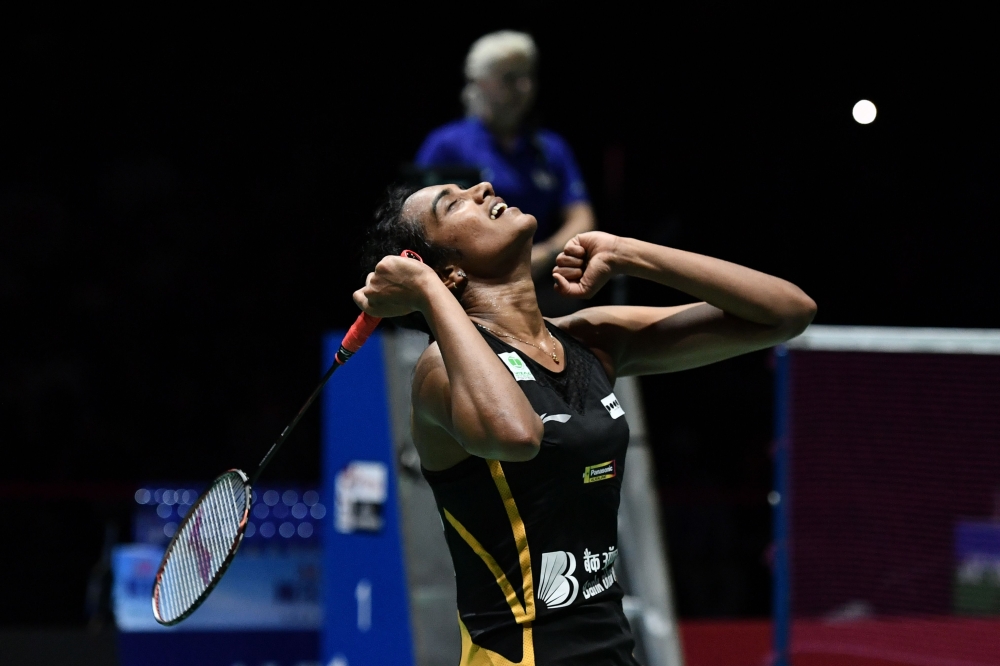 India's Pusarla Venkata Sindhu celebrates after her victory over Japan's Nozomi Okuhara during their women's singles final match at the BWF Badminton World Championships at the St. Jakobshalle in Basel on August 25, 2019. (AFP / FABRICE COFFRINI)