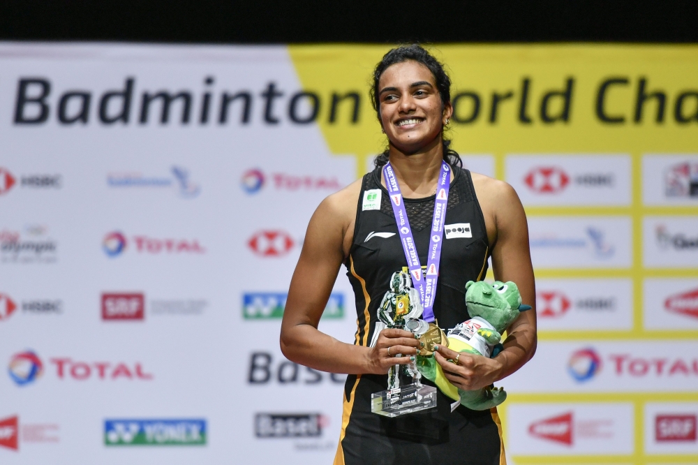 First-placed India's Pusarla Venkata Sindhu poses on with the gold medal during the podium cermony after her victory over Japan's Nozomi Okuhara during their women's singles final match at the BWF Badminton World Championships at the St Jakobshalle in Bas