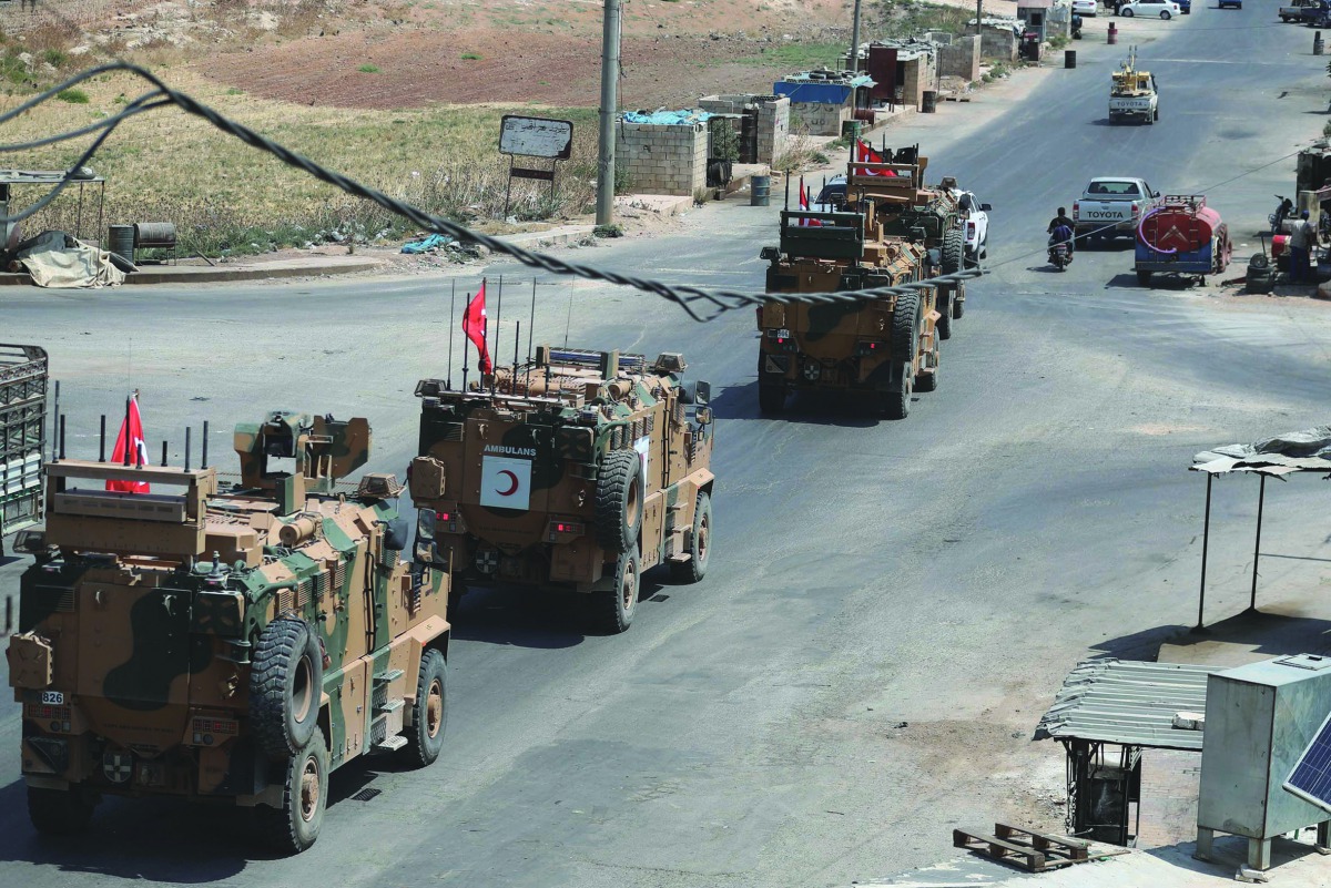 A picture taken on August 29, 2019 shows Turkish military vehicles passing through the town of Saraqib in the northwestern Idlib province. AFP / Omar Haj Kadour
