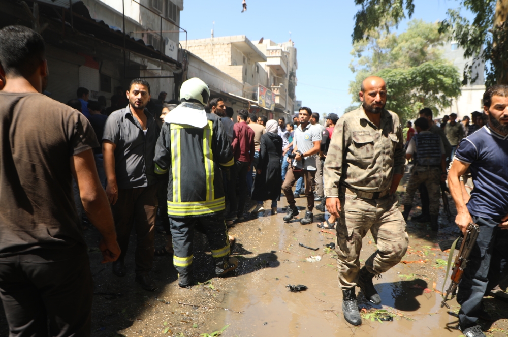 Civil defence crews and residents inspect the site of motorbike explosion killing 1, wounding 11 others in Azaz district of Aleppo, Syria on September 03, 2019. Nayef Abboud - Anadolu 