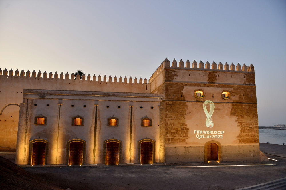 The 2022 Fifa World Cup Qatar logo is projected on the walls of the Oudaya kasbah in the Moroccan capital Rabat on September 3, 2019.  AFP 
