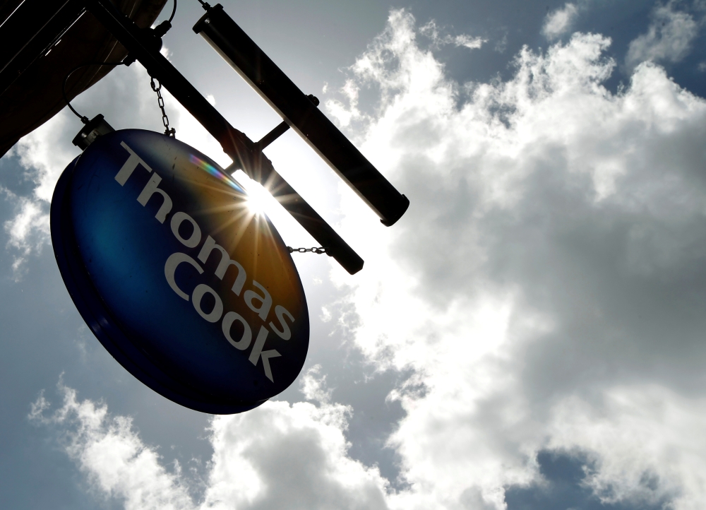 FILE PHOTO: A sign hangs in front of a branch of travel agent Thomas Cook in London May 9, 2011. REUTERS/Luke MacGregor/File Photo