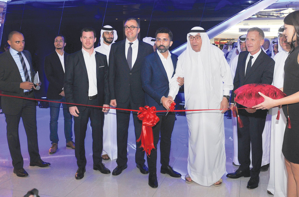 Dr. Hamid Haqparwar (centre), Managing Director of BMW Middle East, and Hussain Ibrahim Alfardan, Chairman of Alfardan Group, cutting the ribbon with other officials, during the opening of the 
BMW M power section and unveiling of new BMW M X4 and M850i 