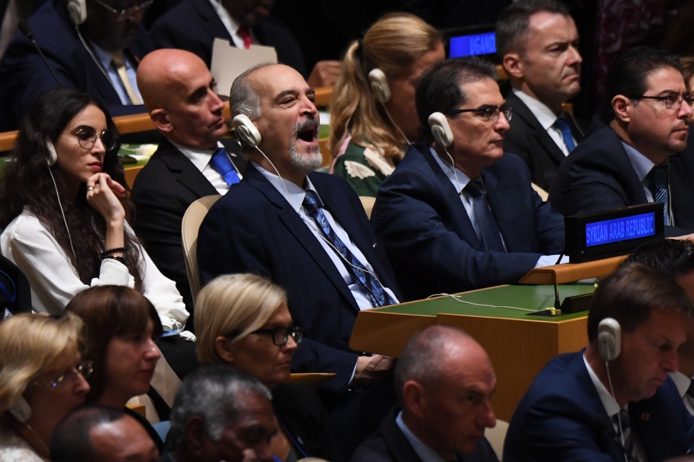 Delegates from Syria listen as US President Donald Trump speaks during the 74th Session of the United Nations General Assembly at UN Headquarters in New York, September 24, 2019. / AFP / SAUL LOEB