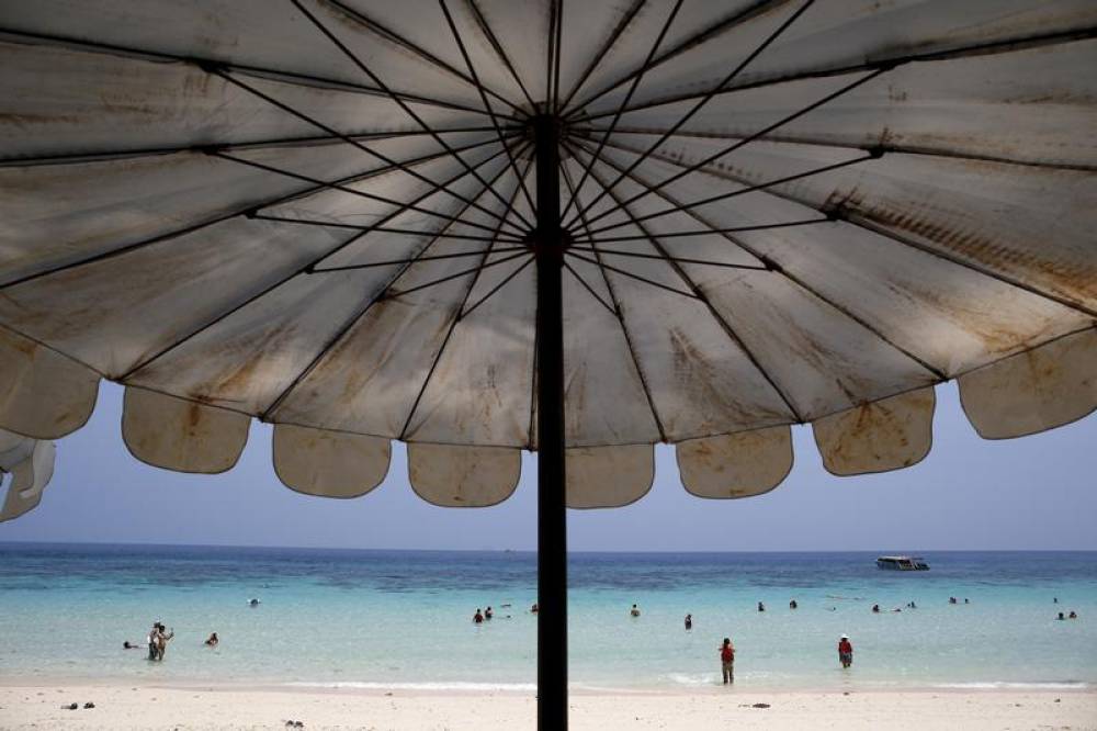 Tourists are seen on a beach in Phuket, Thailand March 18, 2016. Reuters/Athit Perawongmetha