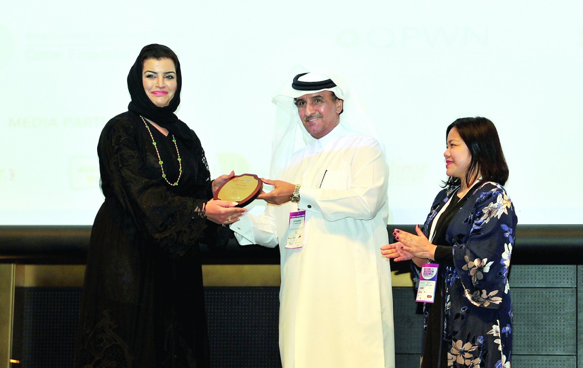 Dr Khalid Klefeekh Al Hajri (centre), Board Member, Qatar Chamber, presenting an award to Aisha Alfardan, Vice-Chairwoman, Qatar Businesswomen Association, after her keynote speech at the opening of the Doha Women’s Forum, held at the Westin Hotel in Doha