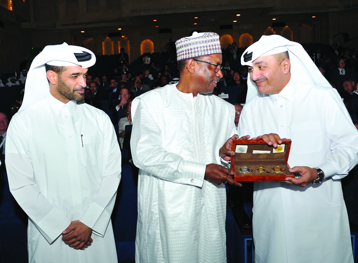 The Minister of Administrative Development, Labour and Social Affairs, H E Yousuf Mohamed Al Othman Fakhroo, presenting a memento to Deputy Director-General for Field Operations and Partnerships, International Labour Organization (ILO), Moussa Oumarou, in