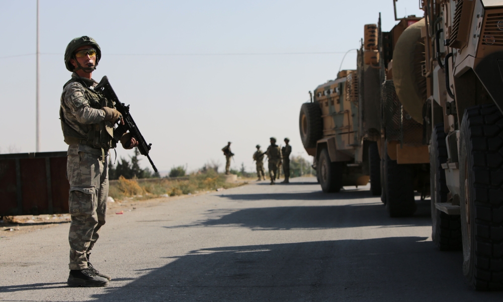 Turkish soldiers patrol the northern Syrian Kurdish town of Tal Abyad, on the border between Syria and Turkey, on October 23, 2019.  AFP / Bakr ALKASEM