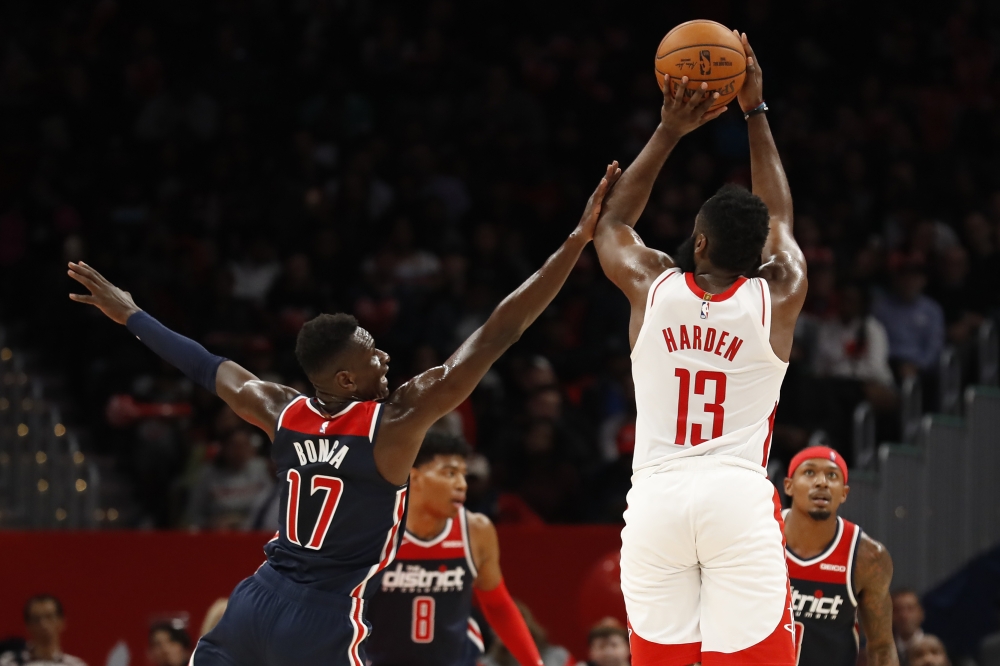 Houston Rockets guard James Harden (13) shots the ball while being fouled by Washington Wizards guard Isaac Bonga (17) in the fourth quarter at Capital One Arena.