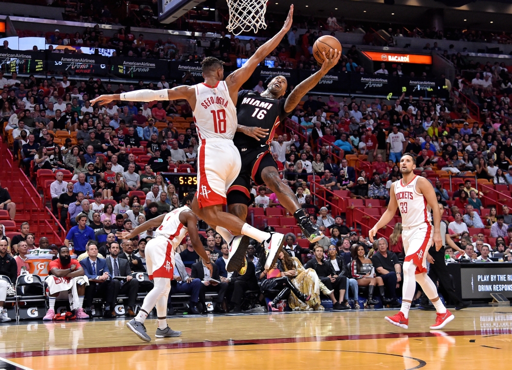 Miami Heat forward James Johnson (16) shoots defended by Houston Rockets forward Thabo Sefolosha (18) during the second half at American Airlines Arena. Mandatory Credit: Steve Mitchell-USA TODAY Sports