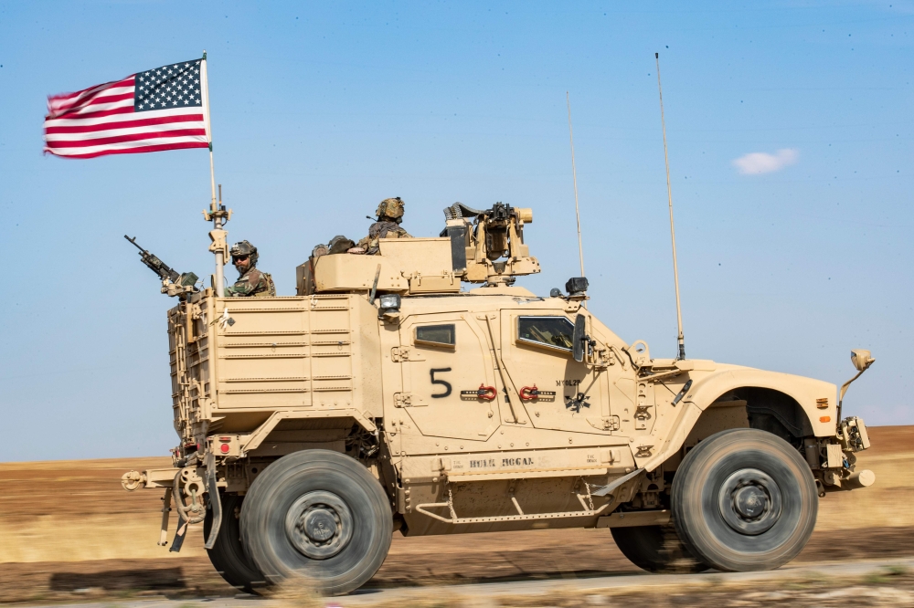 A US armoured vehicle patrols the northern countryside of the northeastern Syrian town of al-Malikiyah (Derik) at the border with Turkey, on November 3, 2019. / AFP / Delil SOULEIMAN