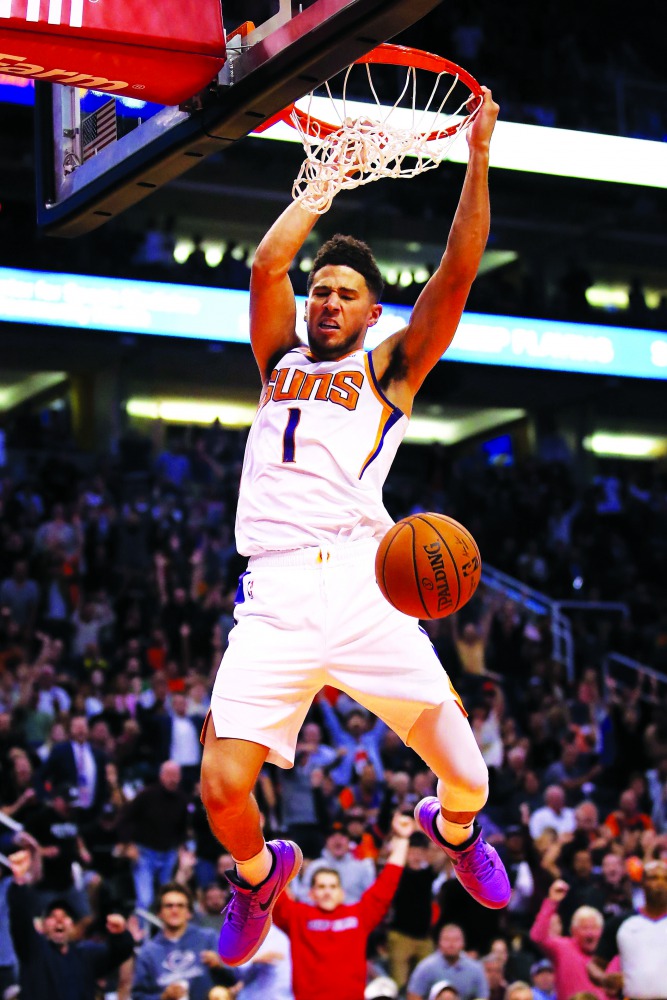  Devin Booker #1 of the Phoenix Suns slam dunks the ball against the Philadelphia 76ers during the second half of the NBA game at Talking Stick Resort Arena on November 04, 2019 in Phoenix, Arizona. Christian Petersen/Getty Images/AFP