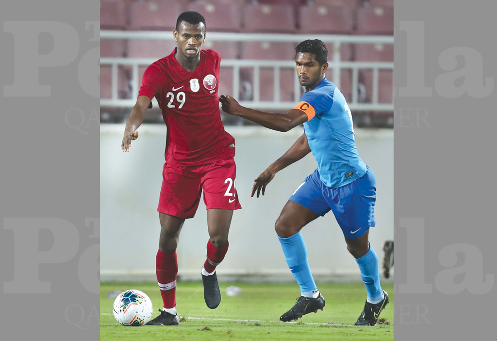 Qatari and Singaporean players in action during their friendly match played at the Abdullah Bin Khalifa Stadium yesterday. 