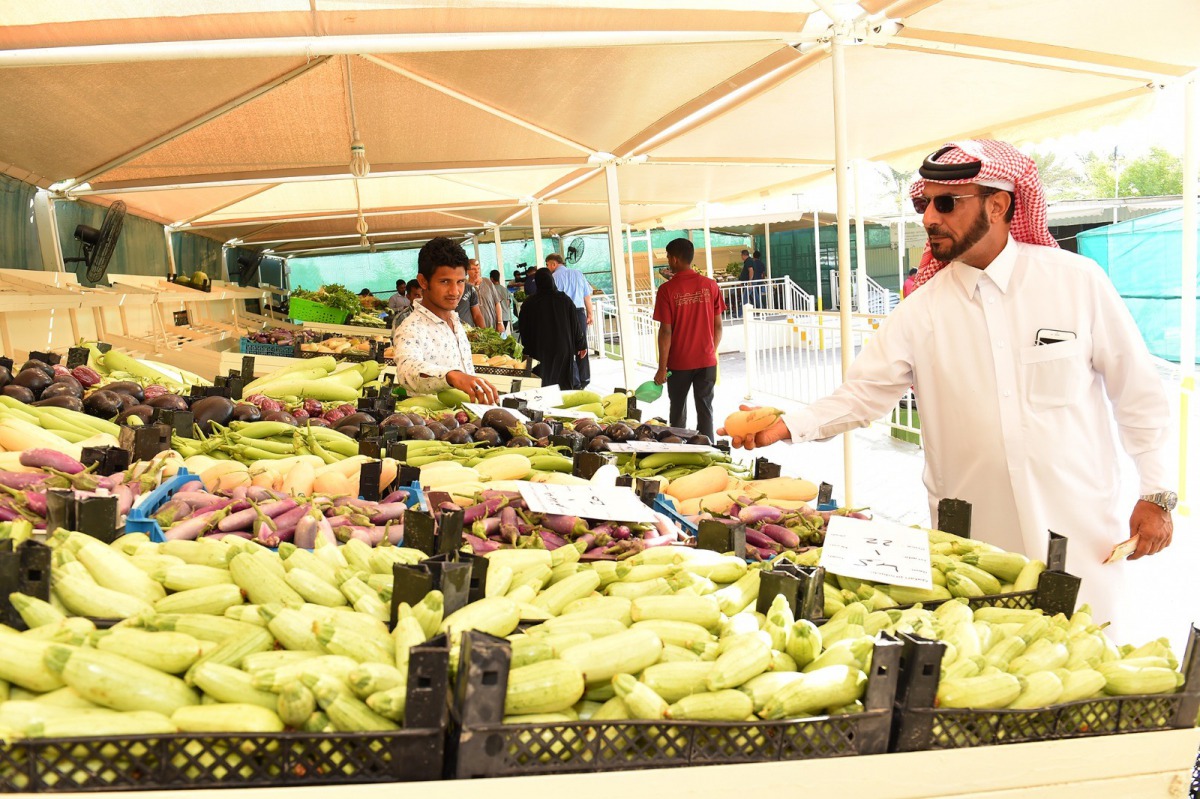 A customer buying vegetables from winter vegetable market that opened yesterday