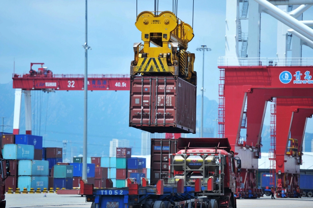 A container is transferred at a port in Qingdao, Shandong province in eastern  China on July 6, 2018. AFP