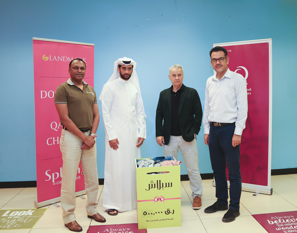 A representative of Qatar Charity receiving the in-kind donation provided by Landmark Group.