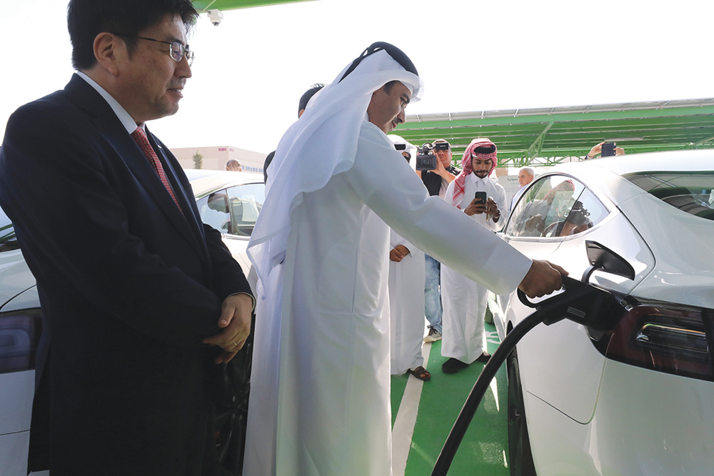 President of Kahramaa, Eng. Essa bin Hilal Al Kuwari, charging an electric car at the newly-opened charging station, yesterday.