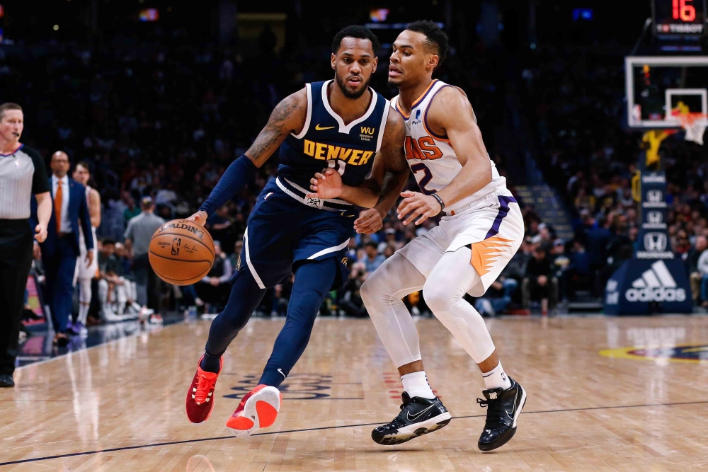 Denver Nuggets guard Monte Morris (11) controls the ball as Phoenix Suns forward Elie Okobo (2) guards in the fourth quarter at the Pepsi Center. Isaiah J. Downing