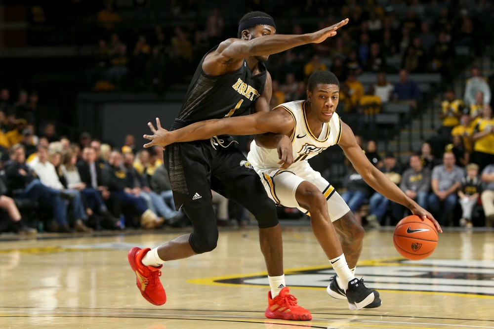 RICHMOND, VA - NOVEMBER 25: KeShawn Curry #11 of the VCU Rams drives against Leon Daniels #1 of the Alabama State Hornets in the second half at Stuart C. Siegel Center on November 25, 2019 in Richmond, Virginia. Ryan M. Kelly/AFP 