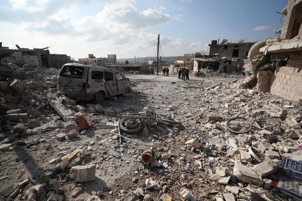 TOPSHOT - Residents check the damage following reported air and helicopter raids by Russian and Syrian regime forces in the town of Al-Bara in the south of Syria's Idlib province on December 7, 2019. / AFP / Omar HAJ KADOUR