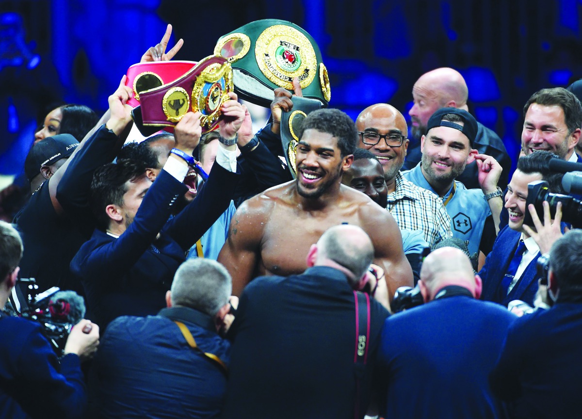 British boxer Anthony Joshua celebrates after winning the heavyweight boxing match between Andy Ruiz Jr. and Anthony Joshua for the IBF, WBA, WBO and IBO titles in Diriya, near the Saudi capital on December 7, 2019. AFP / Fayez Nureldine