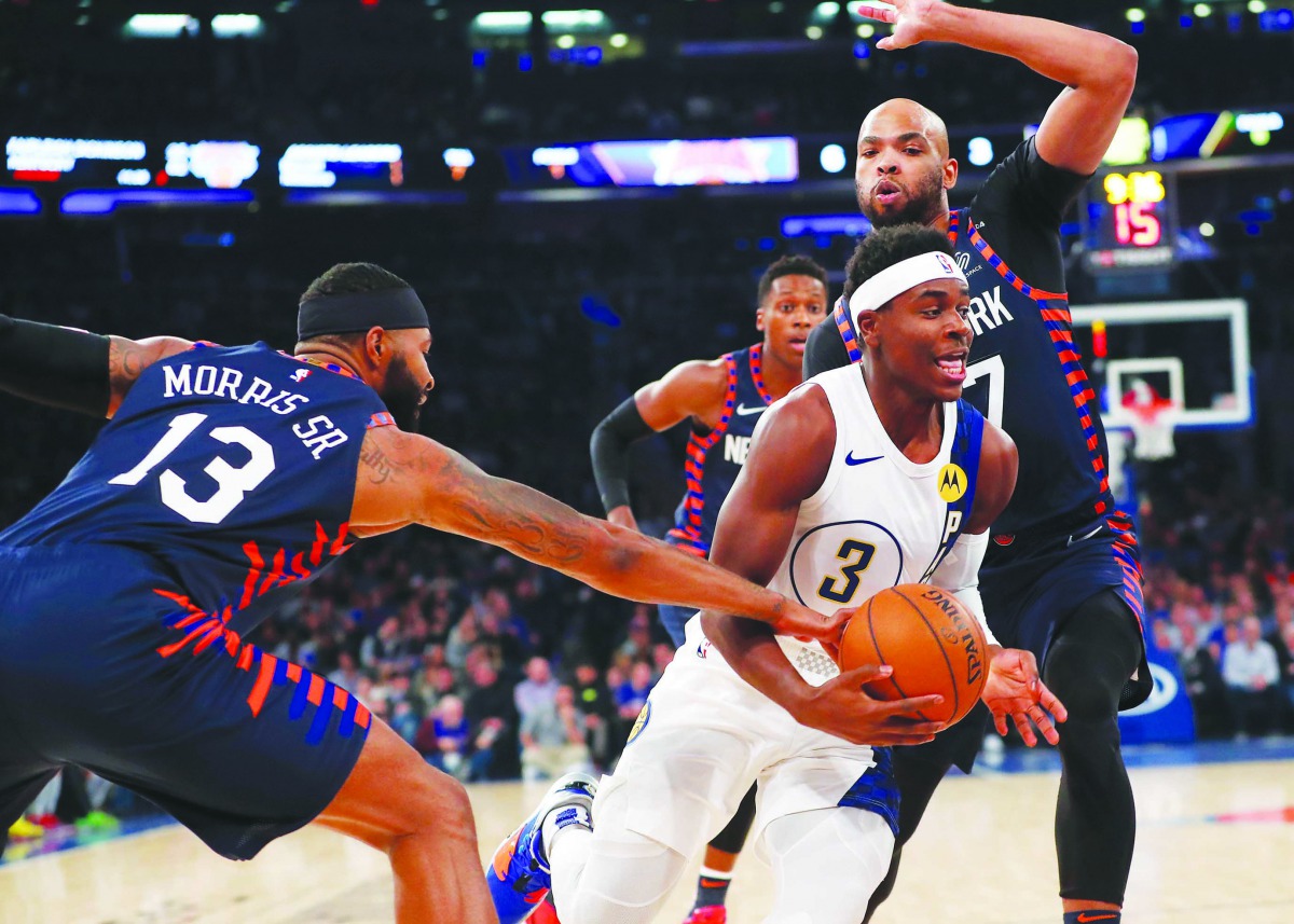 Indiana Pacers guard Aaron Holiday (3) drives to the basket against New York Knicks forward Marcus Morris Sr. (13) and forward Taj Gibson (67) during the first half at Madison Square Garden. Credit: Noah K. Murray-USA TODAY Sports
