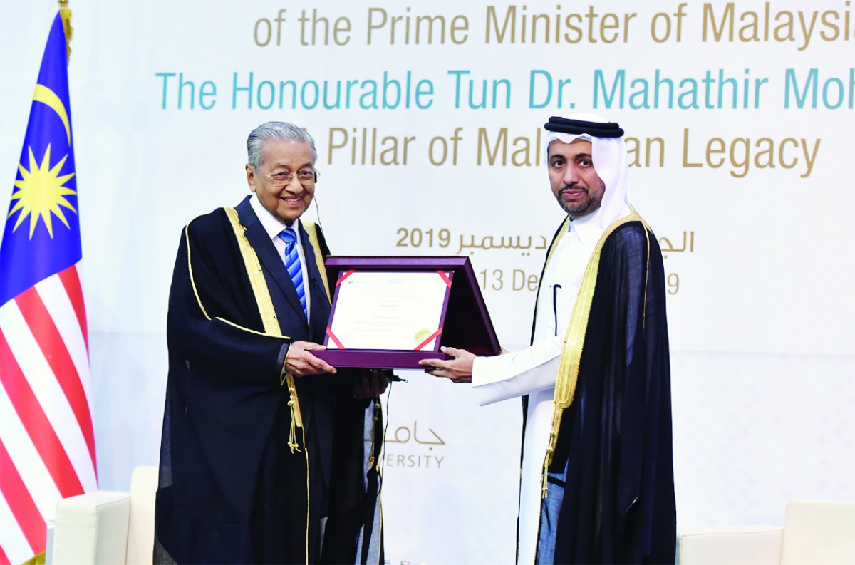 The Prime Minister of Malaysia, H E Dr. Mahathir Mohamad, being conferred with Honorary Doctorate of Philosophy by the President of Qatar University, Dr. Hassan Rashid Al Derham, at Qatar University yesterday.