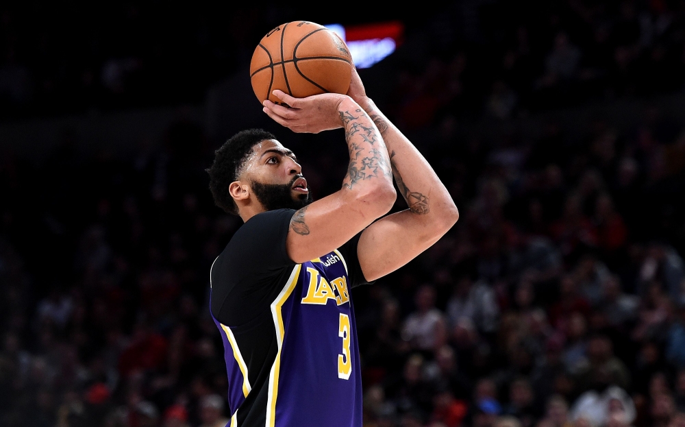 FILE PHOTO: Anthony Davis #3 of the Los Angeles Lakers shoots a free throw during the second half of the game against the Portland Trail Blazers at Moda Center in Portland, Oregon. AFP / Steve DYKES
