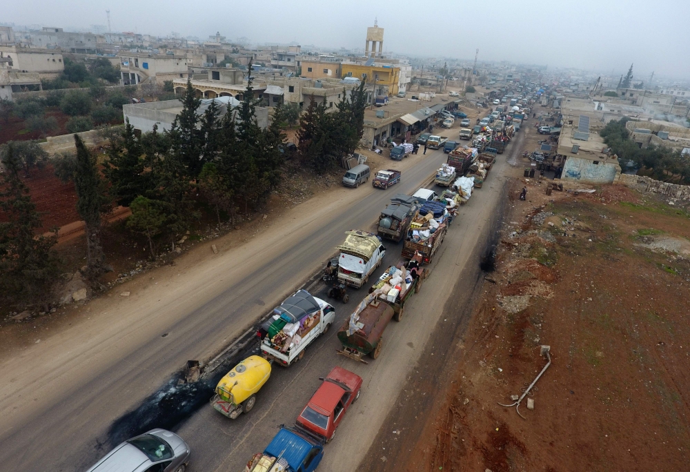 Syrian families from the south of Idlib province driving through the town towards the Syrian-Turkish border as they flee from the assault led by government forces and their allies. December 24, 2019. AFP / Aref TAMMAWI