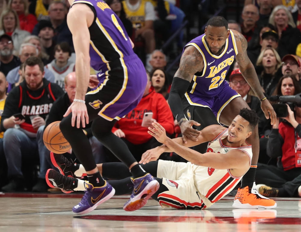 Portland Trail Blazers guard CJ McCollum (3) loses the ball as Los Angeles Lakers forward LeBron James (23) defends in the second half at Moda Center. Jaime Valdez