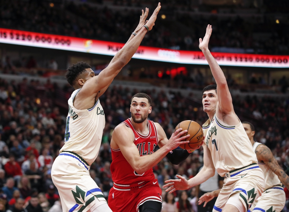 Dec 30, 2019; Chicago, Illinois, USA; Chicago Bulls guard Zach LaVine (8) goes to the basket against Milwaukee Bucks forward Giannis Antetokounmpo (34) and forward Ersan Ilyasova (7) during the second half at United Center. Mandatory Credit: Kamil Krzaczy