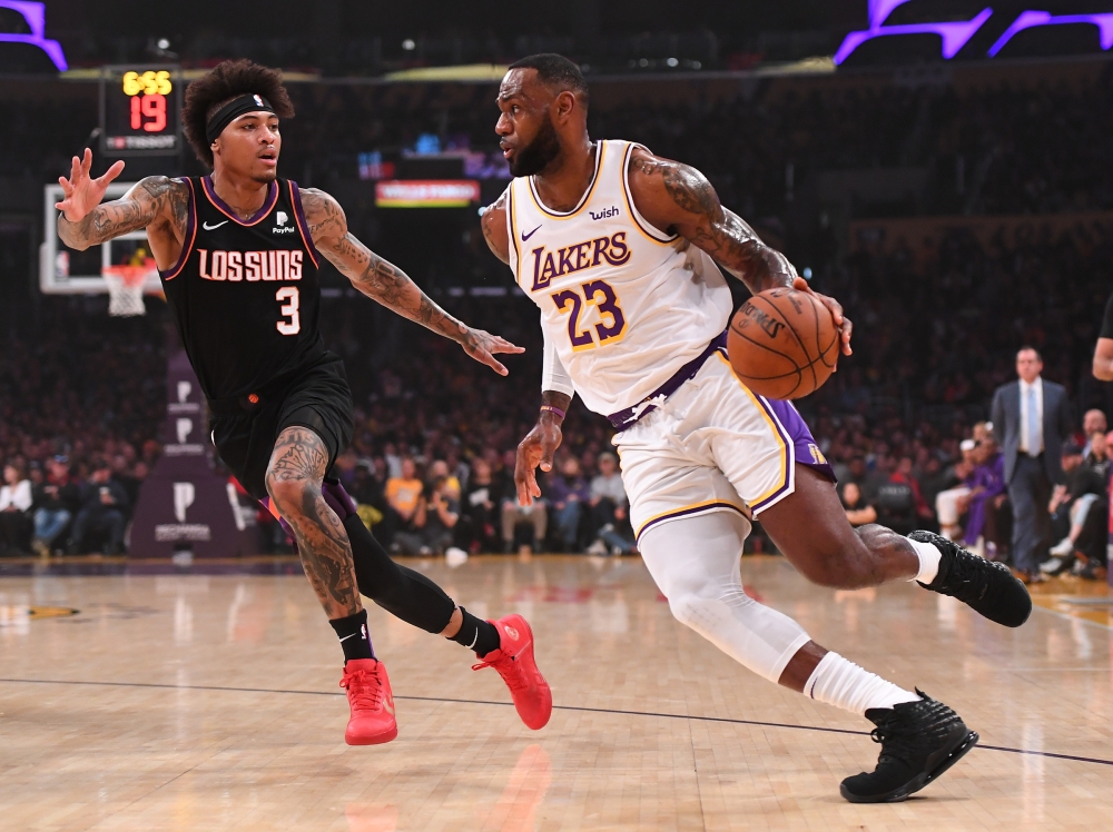 Phoenix Suns forward Kelly Oubre Jr. (3) guards Los Angeles Lakers forward LeBron James (23) as he drives to the basket in the first half of the game at Staples Center. Jayne Kamin