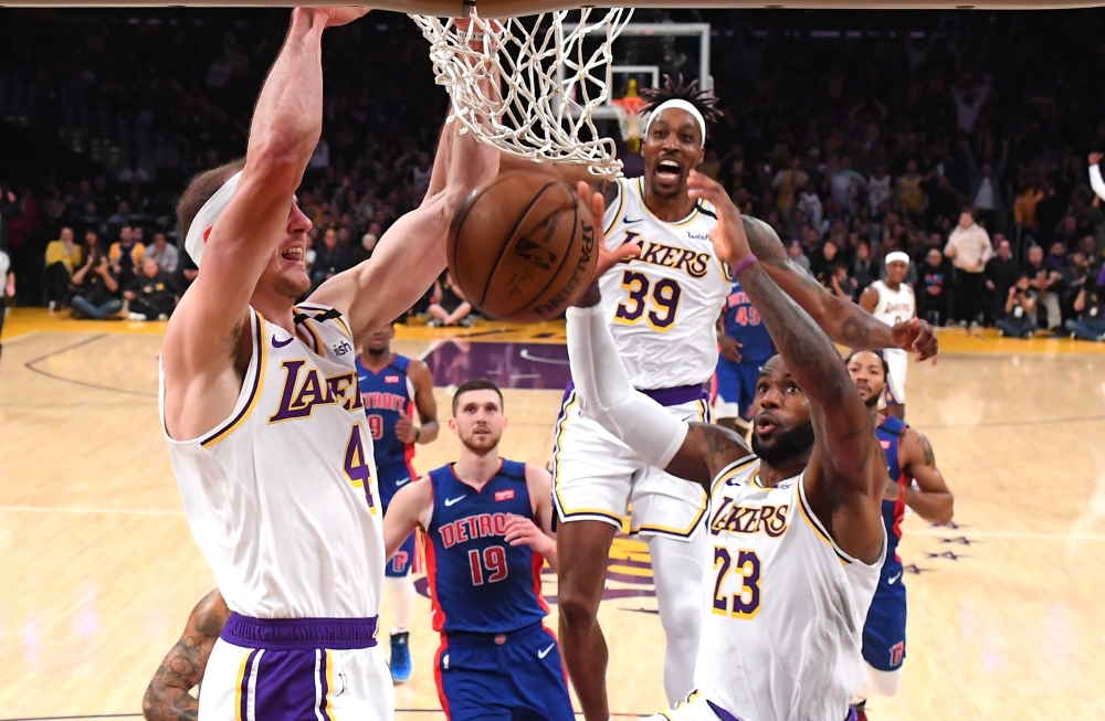 Jan 5, 2020; Los Angeles, California, USA; Los Angeles Lakers center Dwight Howard (39) and forward LeBron James (23) reacts as guard Alex Caruso (4) goes up for a dunk in the second half against the Detroit Pistons at Staples Center. Mandatory Credit: Ja