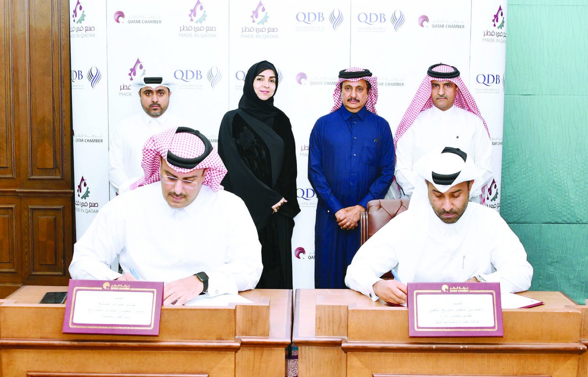 Qatar Chamber (QC) Chairman Sheikh Khalifa bin Jassim Al Thani (standing, second right); QC Board Member and Chair of Industry Committee Rashid bin Nasser Al Kaabi (sitting, right); QDB Executive Director of Business Finance Khalid Abdulla Al Mana (sittin