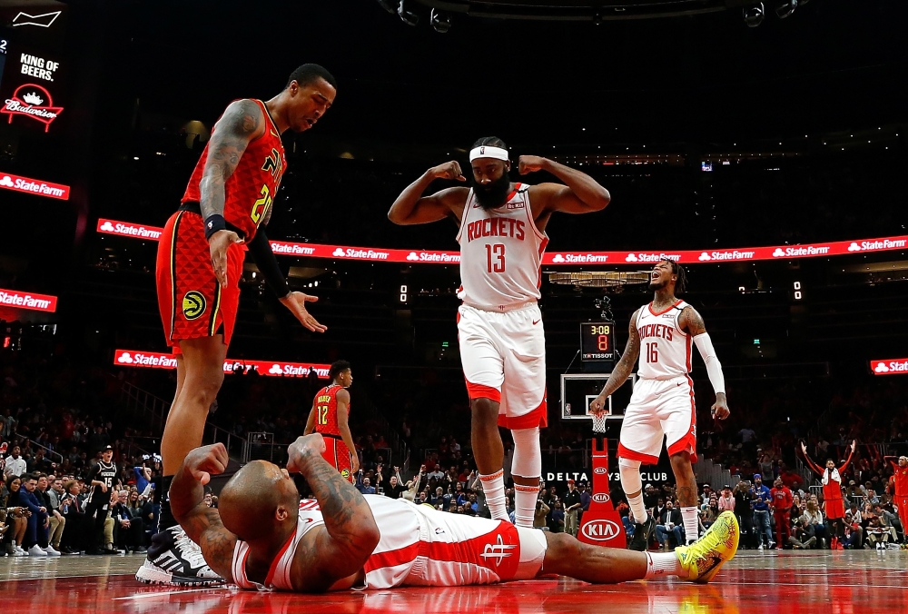 PJ Tucker #17 of the Houston Rockets reacts towards James Harden #13 after drawing a charge from Alex Len #25 of the Atlanta Hawks to force a turnover in the second half at State Farm Arena on January 08, 2020 in Atlanta, Georgia.  Kevin C. Cox/ AFP
