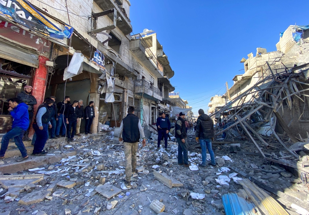 Syrians gather amidst the rubble following regime airstrikes on a market in the town of Binnish in Syria’s northwestern province of Idlib on January 11, 2020. AFP / Omar HAJ KADOUR