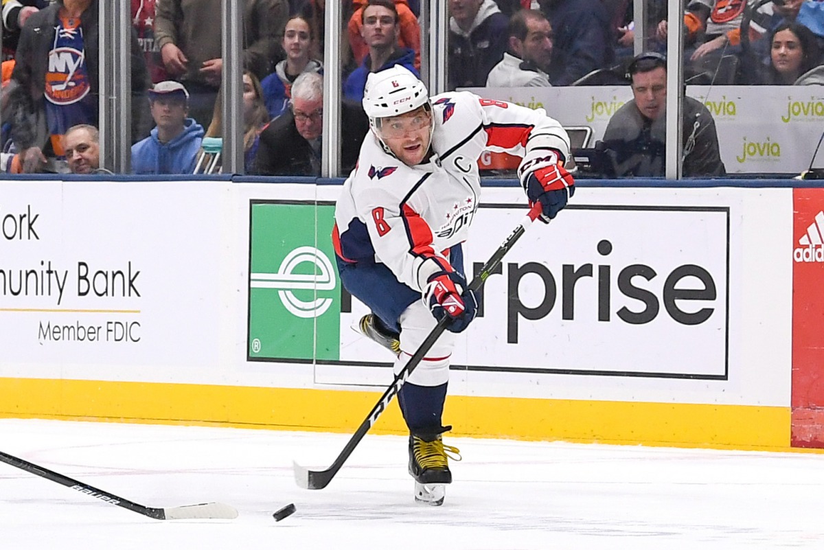 Washington Capitals left wing Alex Ovechkin (8) takes a shot on an empty net against the New York Islanders during the third period at Nassau Veterans Memorial Coliseum. Credit: Dennis Schneidler-USA TODAY Sports 