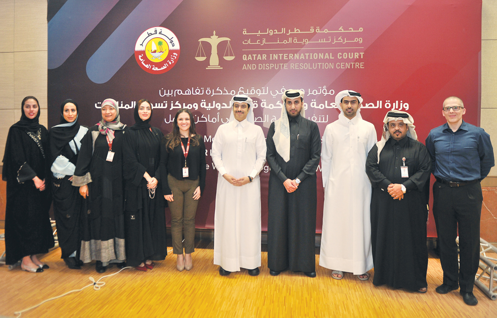 Sheikh Dr. Mohammed bin Hamad Al Thani, Director of Public Health Department at MoPH, and Faisal bin Rashid Al Sahouti, CEO of Qatar International Court and Dispute Resolution Centre, with other officials during the MoU signing ceremony at the Ministry, y