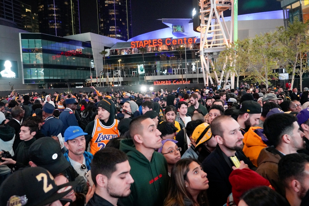 Mourners gather in Microsoft Square near the Staples Center to pay respects to Kobe Bryant after a helicopter crash killed the retired basketball star, in Los Angeles, California, U.S., January 26, 2020. REUTERS/Kyle Grillot