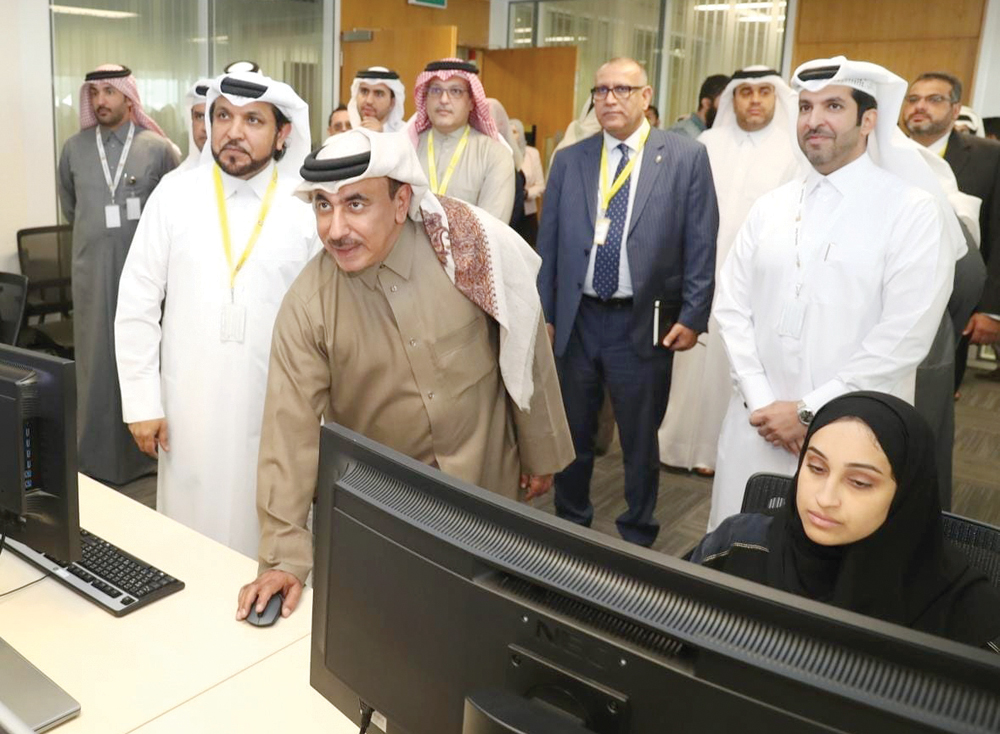 Minister of Transport and Communications, H E Jassim bin Saif Al Sulaiti, launching the Qatar Internet Exchange Point as other officials look on.