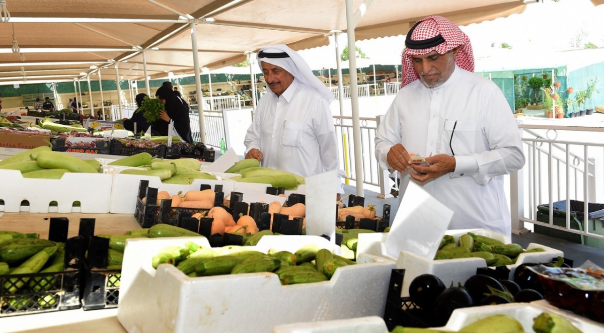 Customers buying vegetables at a winter vegetable market. 